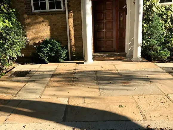 The same entrance paving after restoration, the stone back to an even pale tone